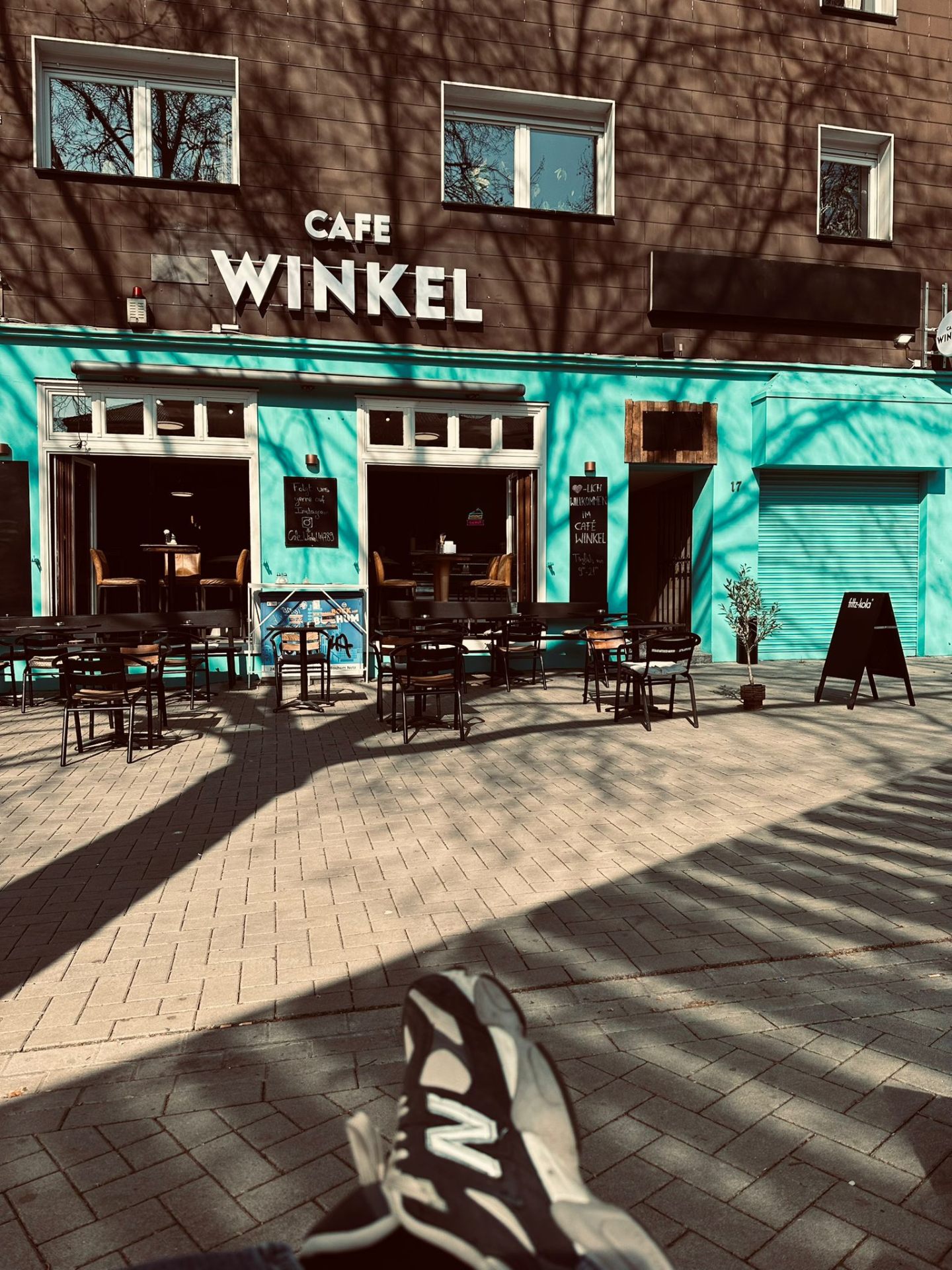 Gemütliches Interieur des Café Winkel in Bochum mit Pflanzen und warmer Beleuchtung